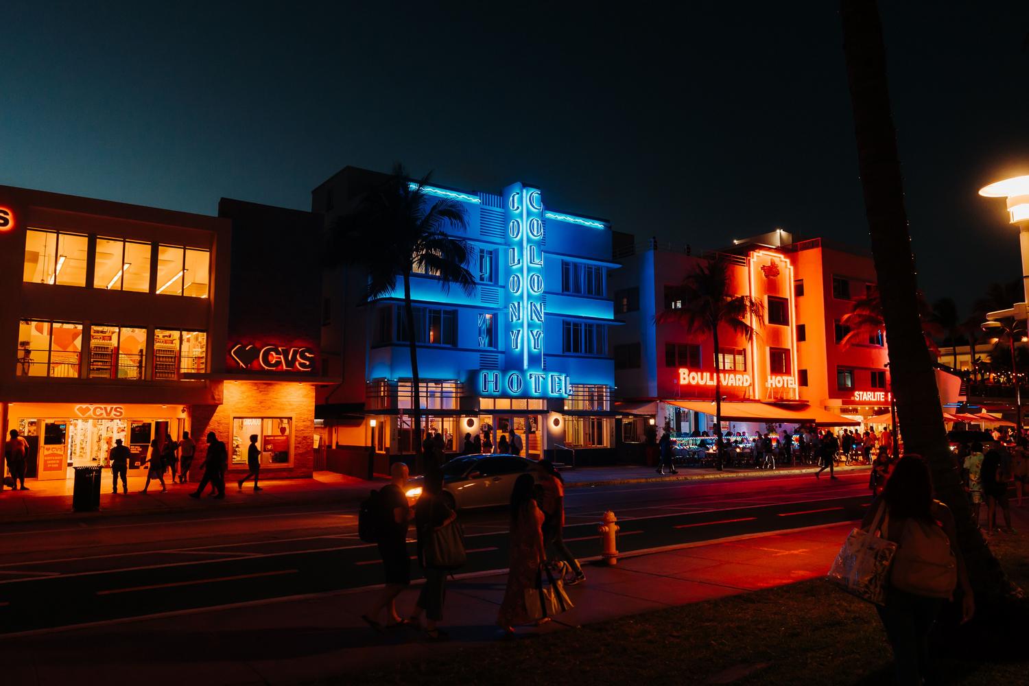 Vibrant nightlife scene on Ocean Drive in Miami with neon lights and Art Deco hotels, representing Vice City.