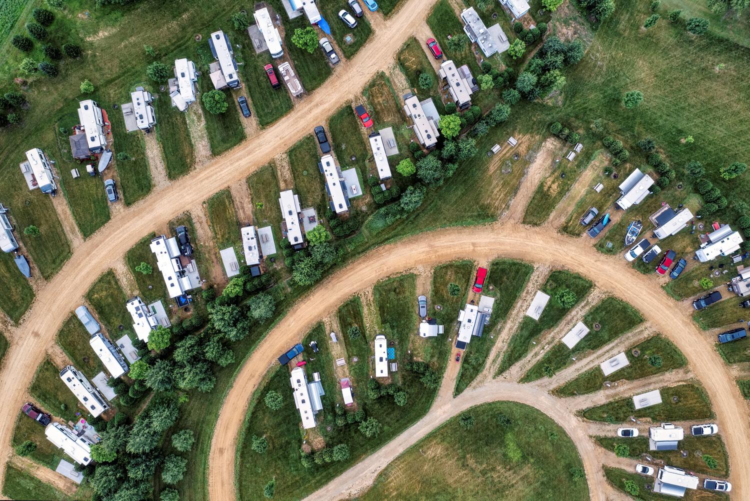 Aerial view of a rural trailer park with RVs and dirt roads, representing the Hamlet region.