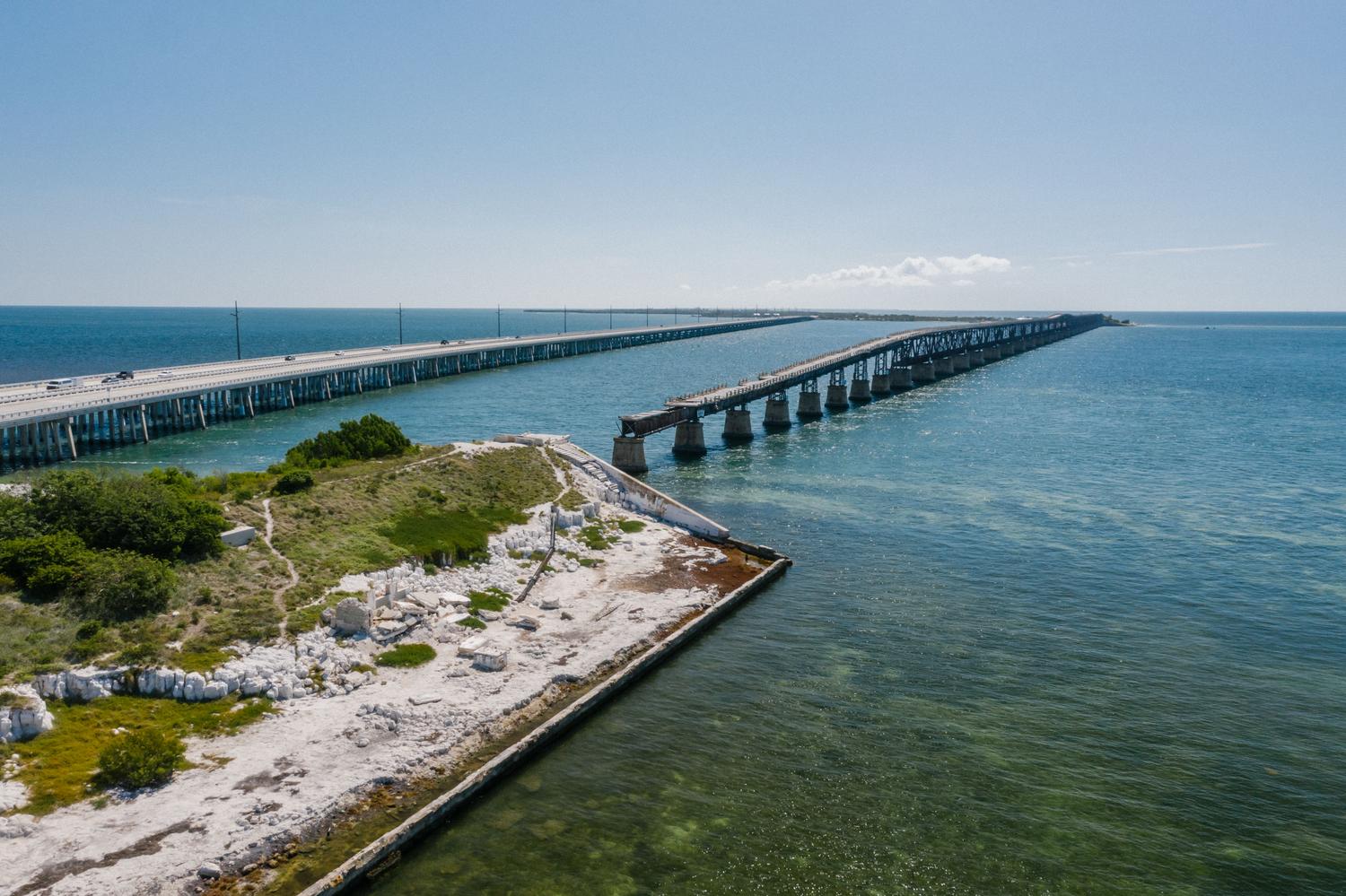 Aerial view of the Seven Mile Bridge over turquoise waters in the Florida Keys, representing Leonida Keys. Aerial view of the Seven Mile Bridge over turquoise waters in the Florida Keys, representing Leonida Keys.