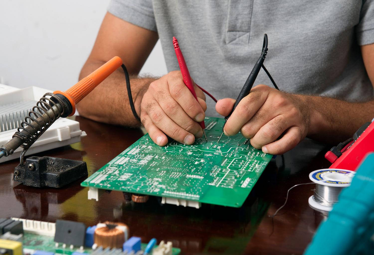 Reparación técnica de una placa electrónica, aludiendo a los fallos de hardware y bootloops en consolas.