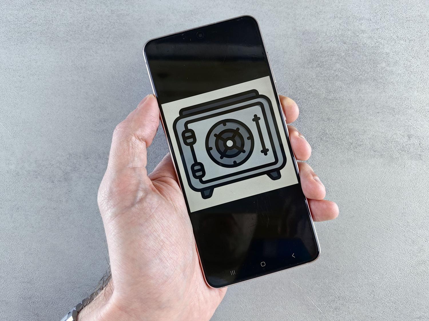 Representación de una caja fuerte digital en la pantalla de un teléfono móvil, ilustrando la protección de datos personales.