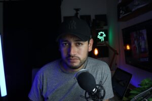 Creador de contenido trabajando en su estudio con micrófono y luces, representando el objetivo de las estafas.
