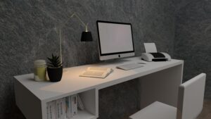 Escritorio blanco moderno y minimalista para home office con ordenador y decoración profesional